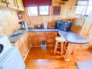 a small kitchen with a counter and a microwave at Yorkdale Cabin in Sabie