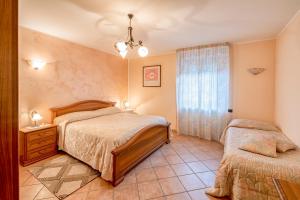 a bedroom with two beds and a window at B&B Matilde in Mormanno