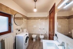 a bathroom with a sink and a washing machine at B&B Matilde in Mormanno