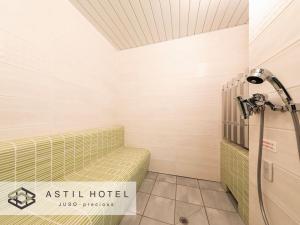 a bathroom with a tub and a shower at Astil Hotel Juso Precious in Osaka
