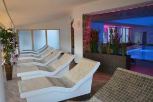 a row of chairs and a swimming pool at Wellness Hotel Garni Krone in Baiersbronn