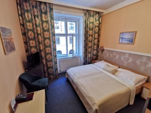 Postel nebo postele na pokoji v ubytování Hotel Bajazzo