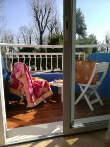 a door open to a balcony with a chair and a bag at Hotel Playa Blanca in Duna Verde