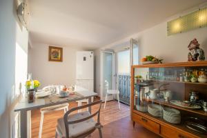 a kitchen with a counter and a table and chairs at Casa Cimino A in Praiano