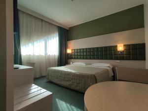 מיטה או מיטות בחדר ב-Guglielmotel