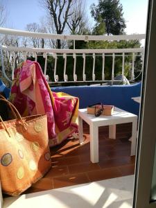 a bench with bags and a table on a balcony at Hotel Playa Blanca in Duna Verde