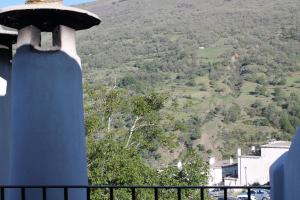 a blue tower with a view of a mountain at Apartamentos Rurales Rosendo: La Canela in Capileira