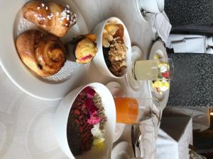 a bunch of pastries on plates on a table at Excelsior Planet in Breuil-Cervinia