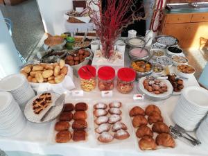 a table topped with lots of different types of pastries at Hotel Playa Blanca in Duna Verde
