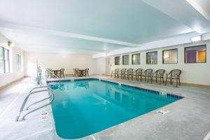 a large swimming pool with chairs in a building at La Quinta by Wyndham Snellville - Stone Mountain in Snellville