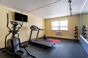 a room with a gym with a treadmill and weights at Days Inn by Wyndham Augusta in Augusta