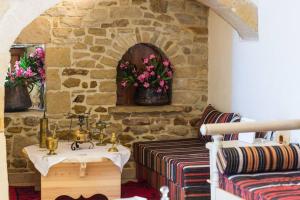 a bathroom with a sink and a stone wall at Villa Stimpolis in Aryiroúpolis