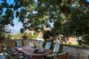 a wooden table and chairs on a patio at Villa Stimpolis in Aryiroúpolis