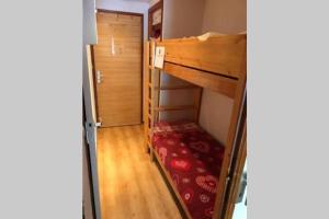 a small room with a bunk bed in a room at Studio 50 m du funiculaire et pistes in Tignes
