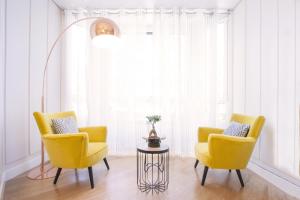 2 sillas amarillas y una mesa en una habitación en Gerezi - Basque Stay en San Sebastián