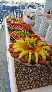 a table with several plates of food on it at Hotel Playa Blanca in Duna Verde