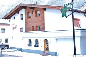 a building in the snow with a garage at Apart Pfeifer in Ischgl