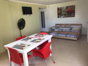 a room with a table and chairs and a bed at CENTRO RENT APART in Federación