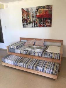 two beds in a room with a painting on the wall at CENTRO RENT APART in Federación
