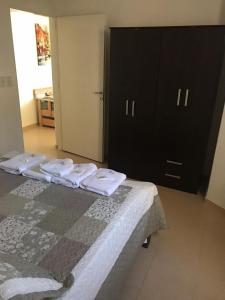 a bedroom with two beds and a black cabinet at CENTRO RENT APART in Federación