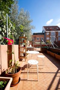 a patio with tables and chairs on a balcony at Charming Madrid Urgel in Madrid