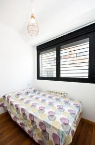 a bed in a room with a window at Charming Madrid Urgel in Madrid
