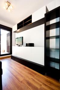 a living room with black and white walls and wooden floors at Charming Madrid Urgel in Madrid