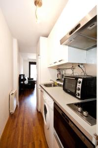 a kitchen with a sink and a stove top oven at Charming Madrid Urgel in Madrid