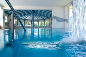 a swimming pool with a water fountain at Hotel Garni Bergblick in Biberach bei Offenburg