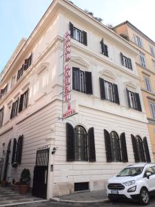 a white building with a sign on the side of it at Hotel Royal Court in Rome