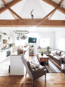 a kitchen and living room with a vaulted ceiling at Chichester Cottage in Funtington