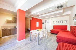 a living room with a red couch and a table at Residence Lenno in Lenno