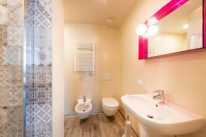 a bathroom with a sink and a toilet and a shower at Residence Lenno in Lenno