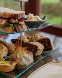 a display of sandwiches and other foods on a table at Glan Brennig in Tregaron