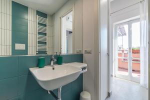 a bathroom with a white sink and a mirror at Piazza Navona Panoramic Penthouse in Rome +23 photos