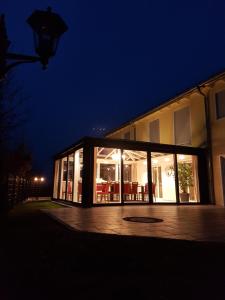 a large building with glass windows at night at Gästehaus Staudenschloss in Mickhausen