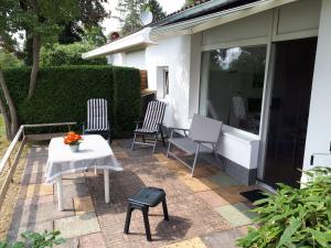 a patio with two chairs and a table at Europapark C7 2-4p in Lichtenau