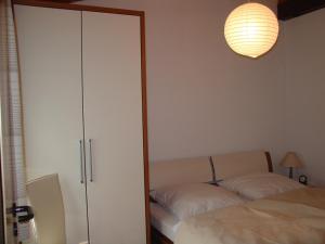 a bedroom with a closet and a bed and a lamp at Type Scout 42 in Ronshausen