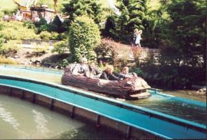 a group of people riding a ride in a log boat in the water at Typ Murmeltier in Schmallenberg