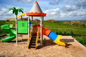 a playground with a slide in the sand at Saab Royale Resort in Kajiado
