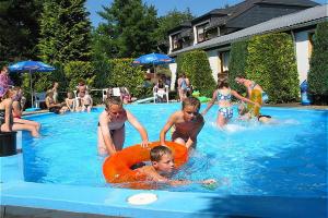 a group of children playing in a swimming pool at Vulkaneifel Type B in Gerolstein