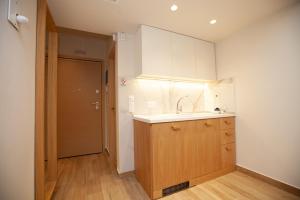 a kitchen with a sink and a wooden cabinet at No21 Luxury Suites in Thessaloniki
