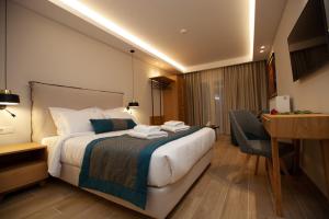 a hotel room with a bed and a desk at No21 Luxury Suites in Thessaloniki