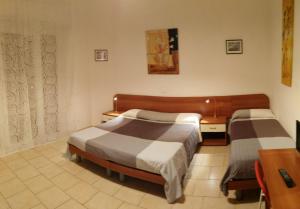 A bed or beds in a room at Residence Hotel Vittoria