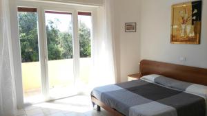 A bed or beds in a room at Residence Hotel Vittoria