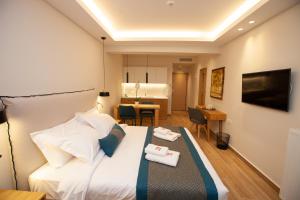 a hotel room with a bed and a dining room at No21 Luxury Suites in Thessaloniki