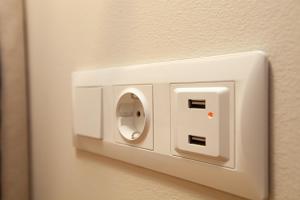 a white light switch on a wall at No21 Luxury Suites in Thessaloniki