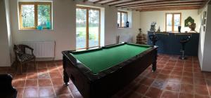 a pool table in the middle of a room at The Magnolias B&B in Moyon