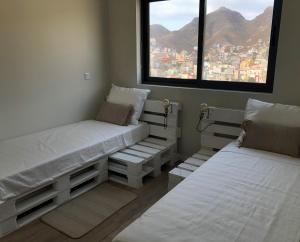 En eller flere senge i et værelse på Harmony apartment in Mindelo São Vicente