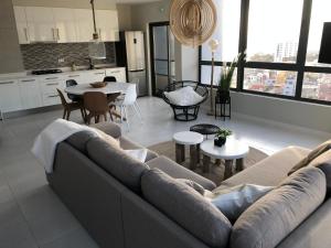 a living room with a couch and a table at Harmony apartment in Mindelo São Vicente in Mindelo